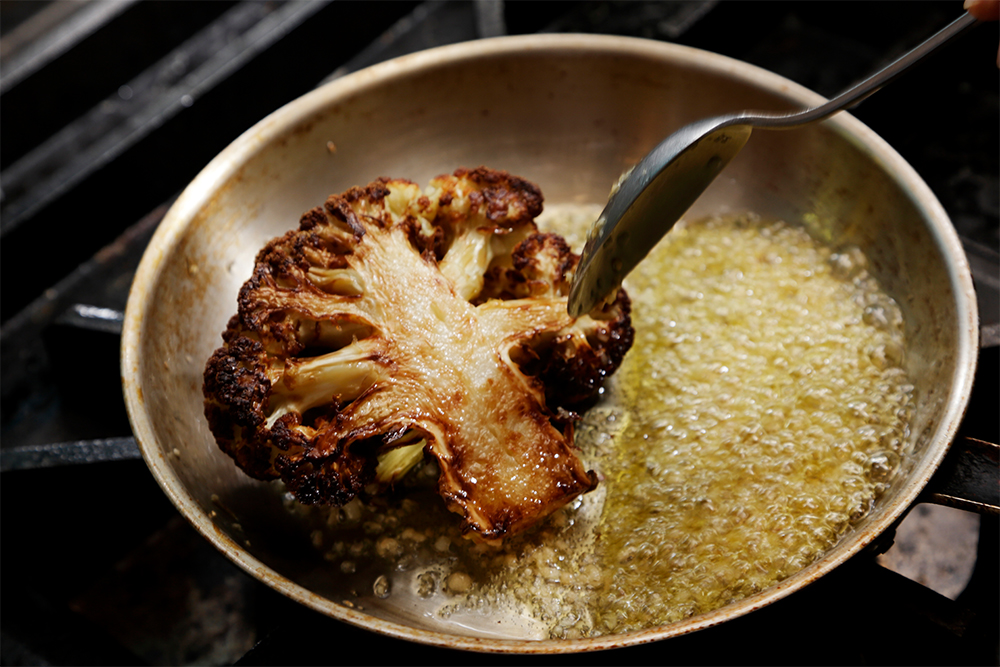 フライパンを傾け、スプーンで油をかけて絡める。 ［６］調味料で風味豊かに