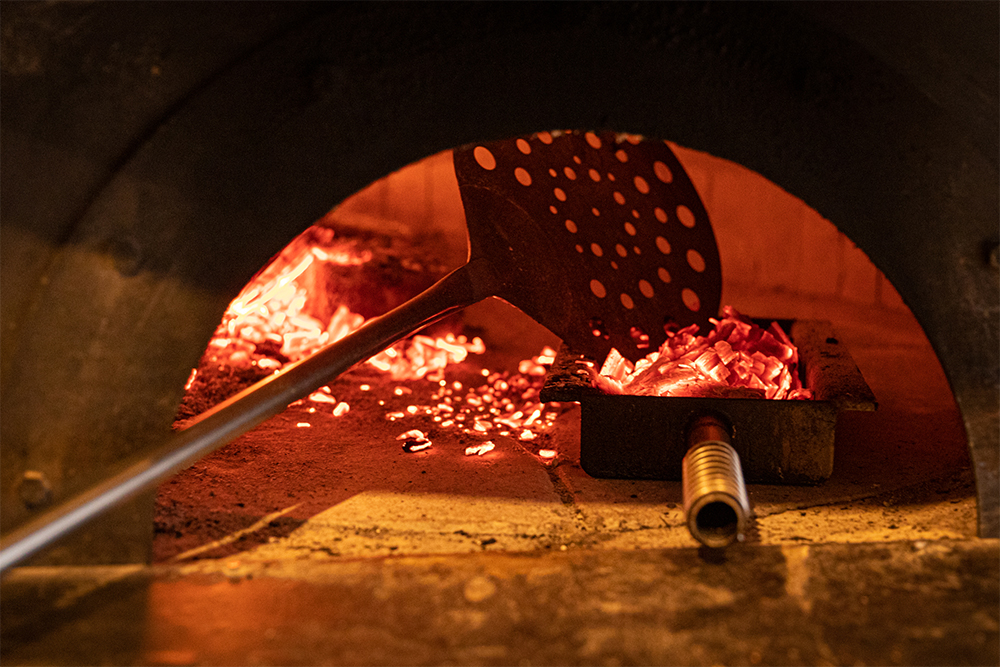 ピッツァ窯の熾火をグリルの熾火トレイに入れる。