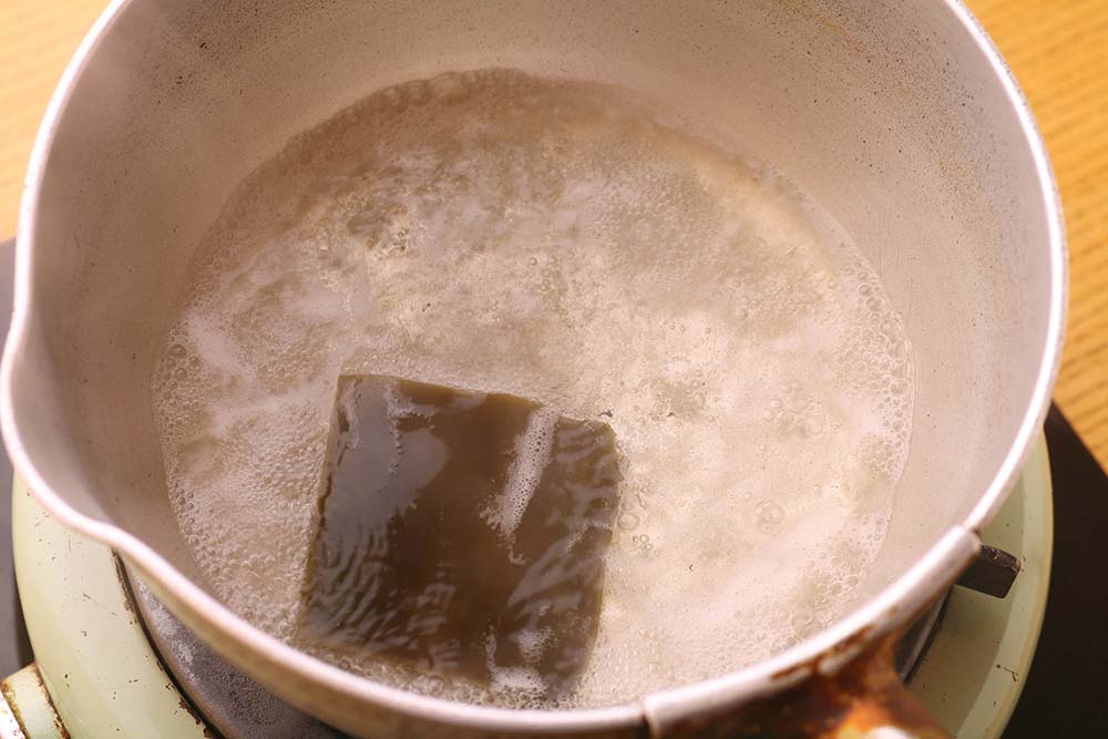 日本酒と昆布を入れて、鍋を中火にかける。 [２]アルコール分を飛ばす